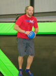 Man Preparing to Throw Dodgeball on a Trampoline